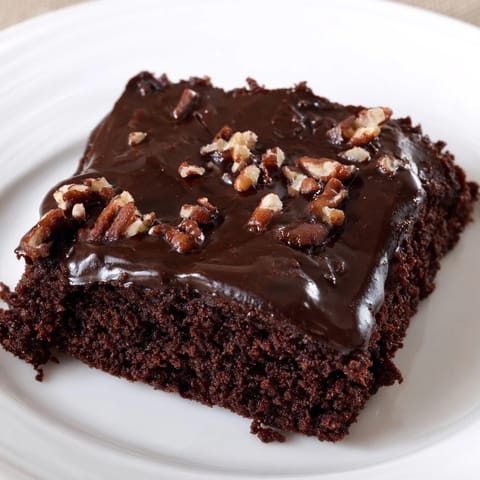 Warm, fudgy icing blankets the surface of this homemade Texas sheet cake, a classic Southern treat.