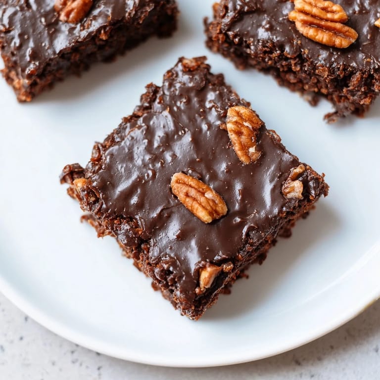 A generous serving of Texas sheet cake, a decadent chocolate dessert with a soft, moist texture.