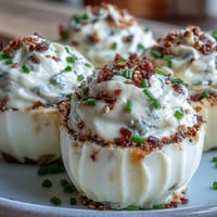 Creamy deviled eggs topped with tangy cream cheese and everything bagel seasoning for a savory brunch bite.