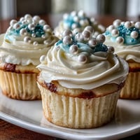 Soft vanilla Cancer birthday cupcakes draped with pearl fondant, a sweet zodiac dessert.